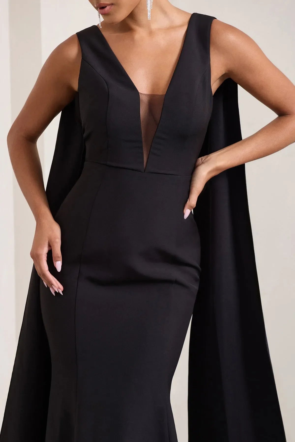 Black Sleeveless Prom Dresses featuring Plunging V - Neck and Striking Cape - Inspired Side Panels Crafted to Dazzle