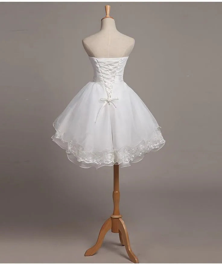 White Romantic Mini Dress with Strapless Neckline Skirt Asymmetric Ruffles and Detailing Ideal for Homecoming Style Statements
