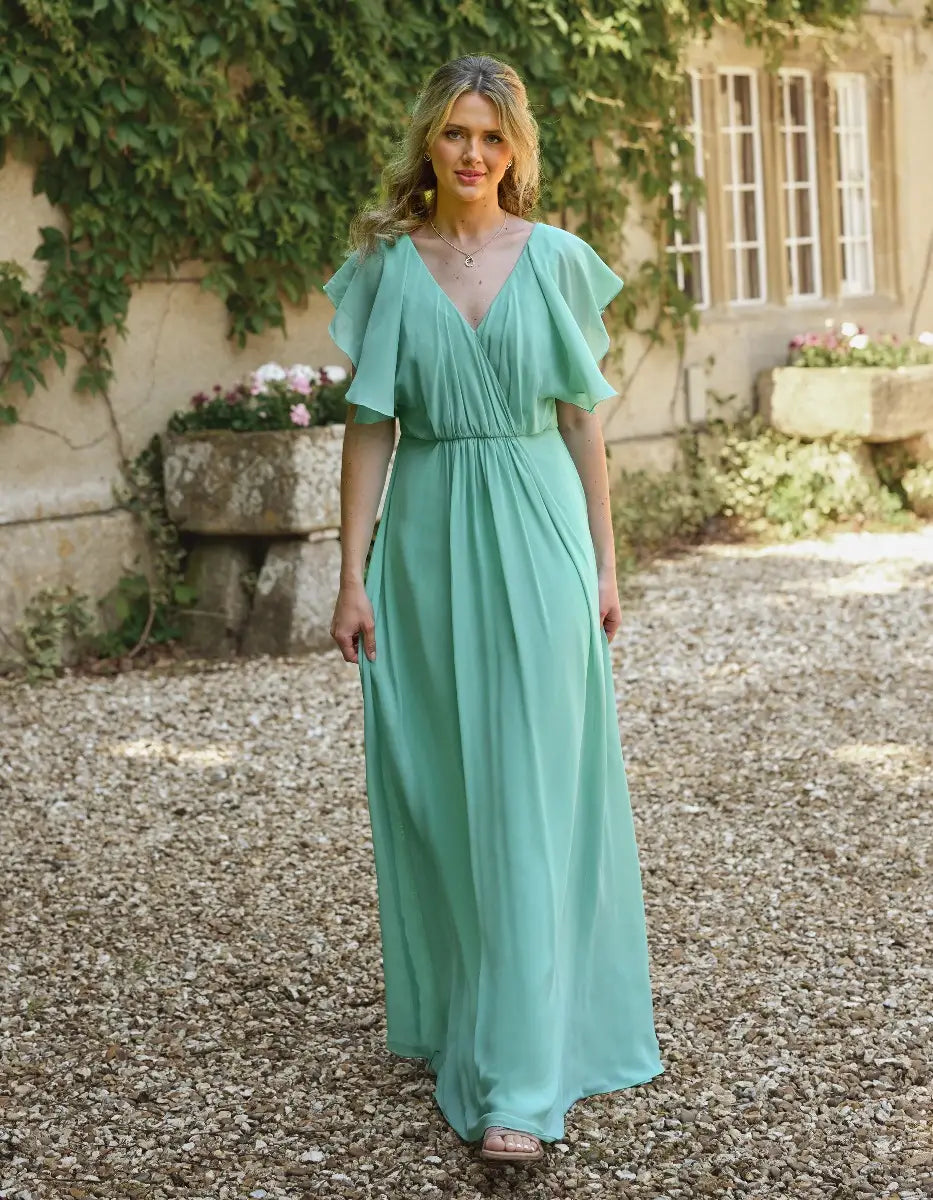 a modern draped bodice with lightweight angel sleeves